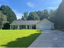 Charming single-story home with a well-manicured lawn and an attached two-car garage at 313 Ridge Hill Cir, Canton, GA 30115