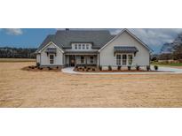 Beautiful single-story home with light gray siding, a gray roof, and a well-manicured lawn at 185 Paislee Park (Lot #10 Paislee Park) Dr, Fayetteville, GA 30215