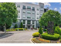 Modern condo building featuring manicured landscaping and tree lined streets at 747 Ralph Mcgill Ne Blvd # 337, Atlanta, GA 30312
