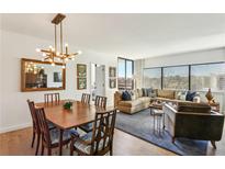 Open-concept living area with dining table, modern lighting, and large windows for natural light at 1130 Piedmont Ne Ave # 907, Atlanta, GA 30309