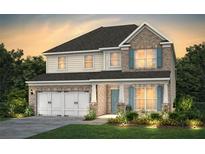 Charming two-story home showcasing a brick facade, complemented by a well-manicured lawn and a two-car garage at 4256 Azalea Ridge Way, Hoschton, GA 30548