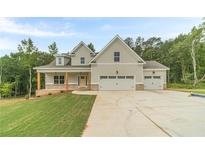 Charming two-story home with a large two-car garage and well-manicured front lawn at 210 Pinewood Dr, Covington, GA 30014