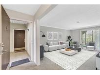 Bright living room featuring a comfortable sofa, modern decor, and abundant natural light at 2390 Lawrenceville Hwy # K, Decatur, GA 30033