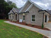 Charming brick home with manicured lawn and landscaping at 25 Fourwood Dr, Covington, GA 30016