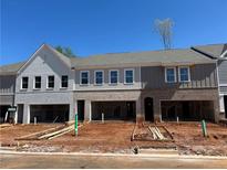 New townhome construction shows two-car garages and mixed brick and board and batten exterior at 125 Priestwood Ln, Acworth, GA 30102
