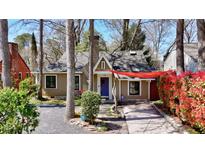 Charming single-story home with a well-manicured front yard, red accents, and a welcoming entrance at 156 Sisson Ne Ave, Atlanta, GA 30317