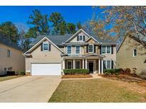 Charming two-story home featuring a manicured lawn and a classic architectural design at 173 Northshore Xing, Dallas, GA 30157