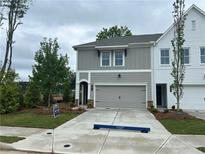 Charming townhome showcasing a two-car garage, neutral paint scheme, and manicured front lawn at 101 Priestwood Ln, Acworth, GA 30102