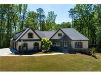 Charming single-Gathering home featuring a well-manicured lawn, a three-car garage, and a timeless design at 447 Lacy Rd, Canton, GA 30115
