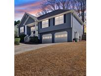 Charming two-story home with a well-manicured lawn and an attached two-car garage at 2593 Abbotts Glen Nw Dr, Acworth, GA 30101