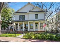 Charming two-story home featuring a well-manicured lawn and a welcoming front porch with stately columns and black framed windows at 273 Glenwood Se Ave # B, Atlanta, GA 30312
