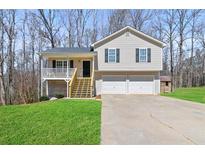Charming two-story home featuring a welcoming front porch and a two-car garage at 38 Wayfaring Ct, Rockmart, GA 30153