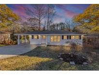 Charming single-story home featuring a well-manicured front yard and a convenient carport on a spacious lot at 2480 Miriam Ln, Decatur, GA 30032