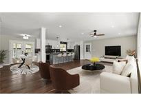 Open-concept living room and kitchen with stainless steel appliances, island seating, and a modern design at 3376 Irish Ln, Decatur, GA 30032
