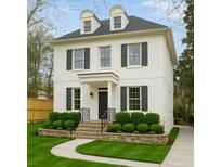 Charming white two-story home with dormer windows, black shutters, and landscaped front yard at 1109 Pine Grove Ne Ave, Brookhaven, GA 30319