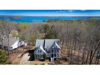 Inviting two-story house featuring a charming porch and scenic lake views at 7492 Shadburn Ferry Rd, Cumming, GA 30041