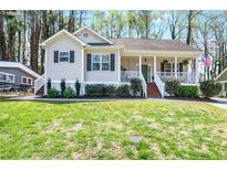 Charming single story home with inviting front porch, manicured lawn, and beautiful curb appeal at 91 Griggs Sw St, Marietta, GA 30064