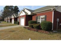 A charming one-story red brick house with a well-manicured lawn and an attached garage at 238 Valley Hill Road Rd, Riverdale, GA 30274