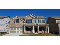 Beautiful brick two-story home with a covered front porch and two-car garage, perfect for Gathering living at 3718 Southfield Ct, Loganville, GA 30052