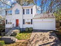 Charming two-story home features a classic design, front yard, and a two-car garage at 4914 October Nw Way, Acworth, GA 30102