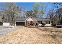 Charming single-Gathering home with a well-manicured lawn, an attached garage, and a cozy front porch at 116 Myrtle Rd, Woodstock, GA 30189