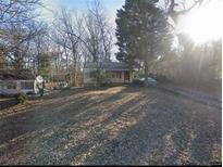 Quaint single-story home with a partially shaded front yard and a driveway leading to a carport at 1650 Terry Mill Se Rd, Atlanta, GA 30316
