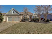 Charming home featuring a brick facade, manicured lawn, and two-car garage on a sunny day at 428 Riverwood Pass, Dallas, GA 30157