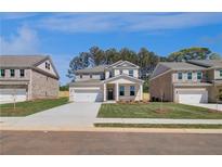 Beautiful two-story home with a two-car garage and well-maintained lawn at 624 Leafy Branch Way, Mcdonough, GA 30253
