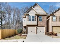 Two-story home featuring two-car garage, brick and siding exterior, and well-manicured landscaping at 2271 Oakland Downs Way, Lawrenceville, GA 30044