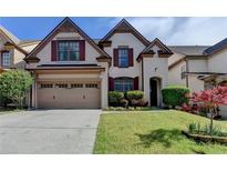 Charming two-story home with a two-car garage, brick accents, and a well-manicured front lawn at 3517 Harvest Ridge Ln, Buford, GA 30519