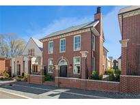 Charming red brick home featuring a classic design, manicured landscaping, and a welcoming entrance at 220 3Rd St, Fayetteville, GA 30214