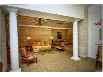 Beautifully decorated lobby with chandelier, columns, seating area, and natural light at 300 Peachtree Ne St # 9A, Atlanta, GA 30308