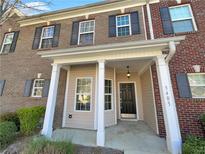 Inviting two-story brick townhouse with charming front porch and decorative black shutters at 2555 Flat Shoals Rd # 3405, Atlanta, GA 30349