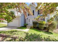 Charming two-story home featuring a well-manicured lawn and inviting front entrance, perfect for families at 4542 White Rd, Douglasville, GA 30135