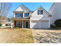 Charming two-story home with a two-car garage, brick accents, and well-maintained landscaping at 813 Topaz Vly, Canton, GA 30114