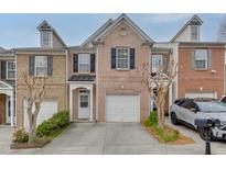 Charming brick townhome with a one-car garage and manicured landscaping at 3826 Dandridge Way, Duluth, GA 30096