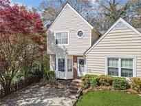 Charming two-story home featuring a well-manicured lawn and tasteful landscaping, complemented by a brick staircase at 5032 Laurel Springs Se Way, Smyrna, GA 30082