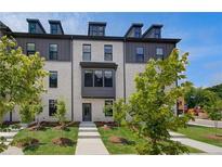Charming townhome with light brick, dark accents, and a well-manicured front yard at 612 Marimba Pike, Mcdonough, GA 30253