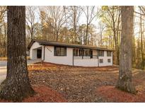 Charming single-story home with a white brick exterior and mature trees in a peaceful setting at 4336 Parkview Dr, Lithia Springs, GA 30122