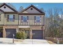 Charming townhome with a brick facade, private garage, and well-maintained landscaping at 1901 Creel Ln, Atlanta, GA 30349