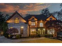 Stunning brick home featuring manicured landscaping, arched windows, and a warm inviting entrance at 2461 Oak Grove Ne Ests, Atlanta, GA 30345