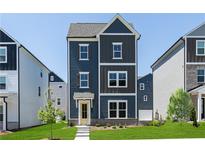 Charming two-story home featuring a combination of siding, shuttered windows, and a well-manicured front lawn at 1366 Creekside Nw Cir, Atlanta, GA 30318