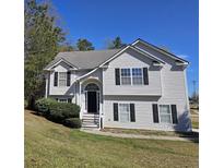 Charming two-story home with black shutters, arched entry and well-maintained lawn on a sunny day at 68 Georgias Ln, Dallas, GA 30157
