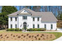 Stately two-story home featuring a white exterior, manicured landscaping, and an inviting entrance at 2376 Massey Ln, Decatur, GA 30033