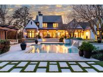 Stunning backyard oasis with pool, spa, waterfall feature, and covered outdoor living space at 5495 Mount Vernon Pkwy, Atlanta, GA 30327