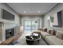 Bright living room with fireplace, modern decor, and sliding glass doors to the outside at 2921 Lenox Ne Rd # 113, Atlanta, GA 30324