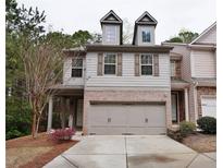 Two-story home with two car garage, brick accents and gable windows at 2620 Sardis Chase Court, Buford, GA 30519