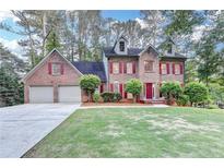 Charming two-story brick home with a well-manicured lawn and a two-car garage at 3253 Brookshire Way, Duluth, GA 30096