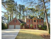 Charming two-story brick home with a well-manicured lawn and mature trees at 3253 Brookshire Way, Duluth, GA 30096