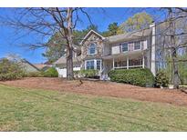 Charming two-story home features stone accents, a covered porch, and well-maintained landscaping at 962 Cove Lake Ct, Lawrenceville, GA 30045